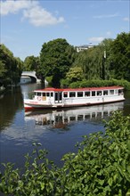 Steamer on the course of the Alster river at the towpath