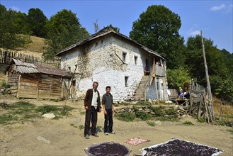 Albanian family in front of their old farmhouse in Cerem