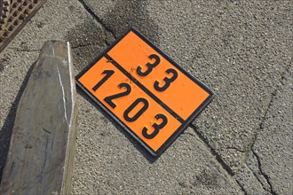 Sign indicating dangerous goods next to a forklift on the ground