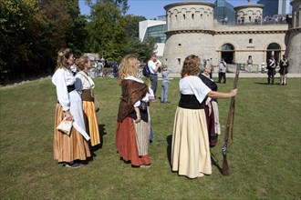 Women with with muzzle-loading rifles during live role-playing or ReenLarpment