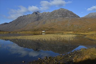 Mountains reflected in a lake in the Highlands in front of Liathach hill