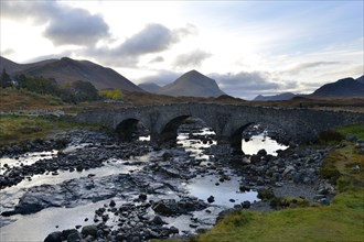 Old stone bridge in front of the Black Cullins Mountains