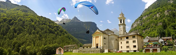 Paragliders over the baroque church at Sonogno