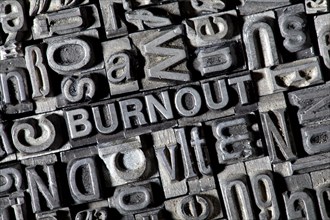 Old lead letters forming the word BURNOUT