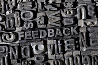 Old lead letters forming the word FEEDBACK