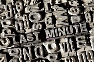 Old lead letters forming the words 'LAST MINUTE'