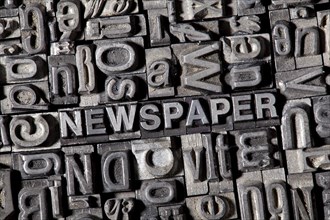 Old lead letters forming the word NEWSPAPER