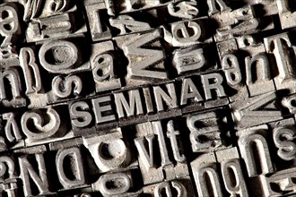 Old lead letters forming the word SEMINAR