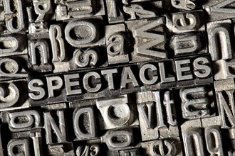 Old lead letters forming the word 'SPECTACLES'