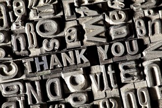 Old lead letters forming the phrase THANK YOU