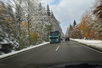 A country road through a snowy forest near Feldkirchen-Westerham