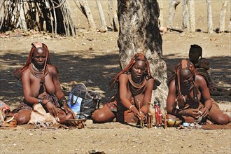 Women selling carvings in a Himba village
