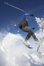 Snowshoe hiker jumping
