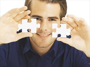 Businessman holding puzzle pieces