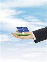 Male hand holding solar cell