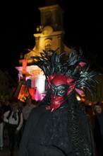 Person with a demonic devil's mask at night