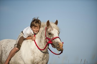 Girl riding a pony bareback