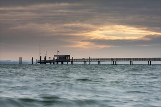 The pier at sunrise in Altnau on Lake Constance