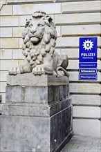 Lion sculpture next to a police station