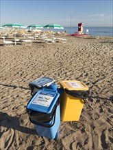 Recycling bins on a beach in Riccione