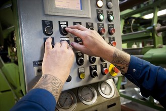 Hands operating a control unit