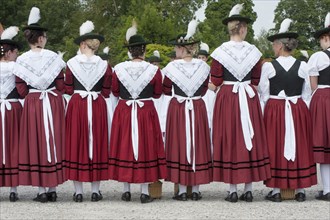 Women in traditional Bavarian costume forming a guard of honour for the entrance into the beer tent