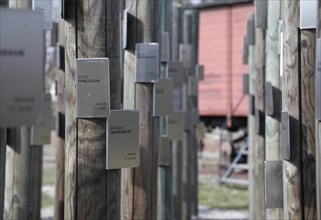 Poles with name tags of Jewish prisoners