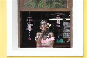 Female figure at a window of a souvenir shop