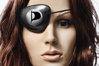 Shop-window mannequin wearing an eye patch with the logo of the Pirate Party of Germany