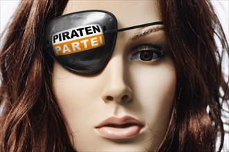 Shop-window mannequin wearing an eye patch with the logo of the Pirate Party of Germany