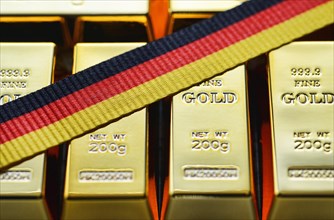 Bars of gold and a ribbon in German national colors