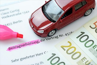Car insurance letter and miniature car