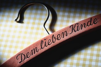 Coat hanger with the words 'Dem lieben Kinde' or 'for the dear child'