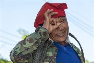 Man from the Shan or Thai Yai ethnic minority imitating a camera by holding his fingers in front of his face