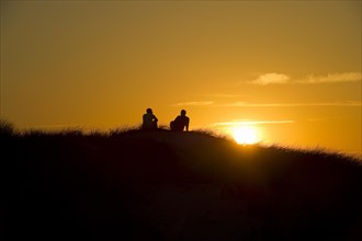 Couple at sunset and dunes
