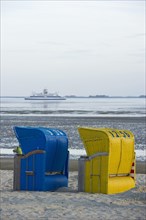 Colourful roofed wicker beach chairs on the beach near Wyk