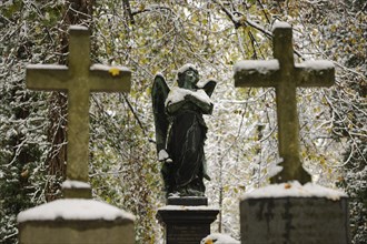 Grave crosses and a statue of an angel