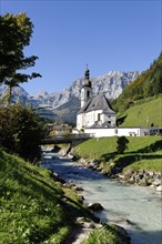 Parish Church of Saint Sebastian and the Ramsau river in front of the Reiteralpe or Reiter Alm mountains