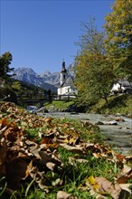Parish Church of Saint Sebastian and the Ramsau river in front of the Reiteralpe or Reiter Alm mountains