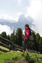 Hiker at the Raschotz or Rasciesa mountain pasture with Mt. Sasso Lungo