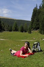 Hiker at the Raschotz or Rasciesa mountain pasture near St. Ulrich