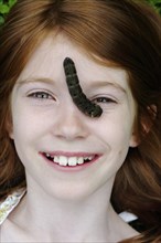 Girl with a caterpillar on her face