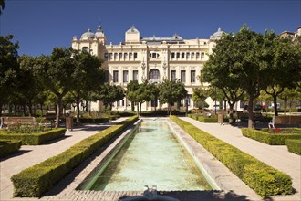 Gardens of Jardines de Pedro Luis Alonso with the Town Hall