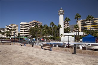 Lighthouse and high-rise buildings on the promenade