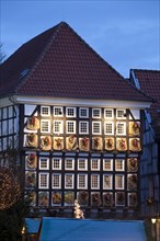 Advent calendar on the facade of the old town hall in the old town at dusk