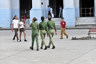 Female soldiers walking through the centre of Santa Clara
