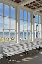 Looking through the window of the pavilion of the Kurhaus spa building towards the Baltic Sea and the beach