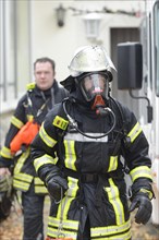 Firefighter wearing breathing equipment during a roof fire