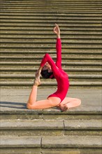 Young woman practising Hatha-Yoga outdoors