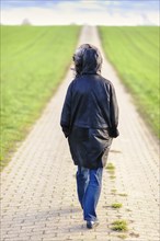 Woman walking on a field path